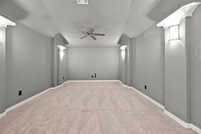 a view of a livingroom with furniture and a ceiling fan