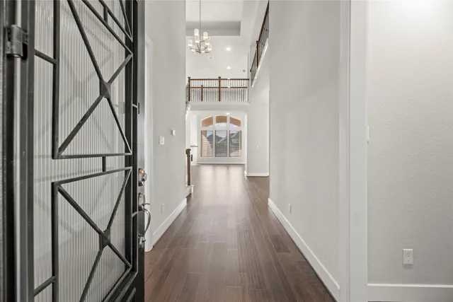 a view of hallway with wooden floor