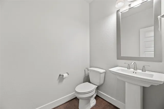 a bathroom with a sink toilet and a mirror