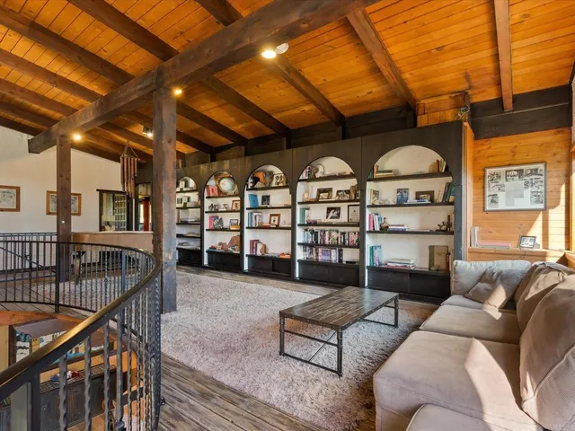a living room with furniture a rug and a chandelier