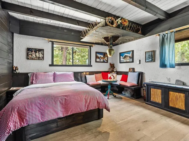 a bedroom with a bed a stove and potted plants