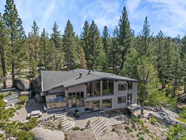 an aerial view of a house with a yard patio and backyard