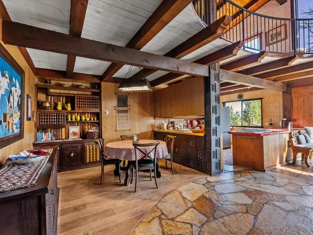 a view of a dinning room with wooden floor and furniture