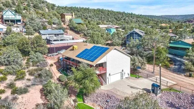 an aerial view of a house with a yard