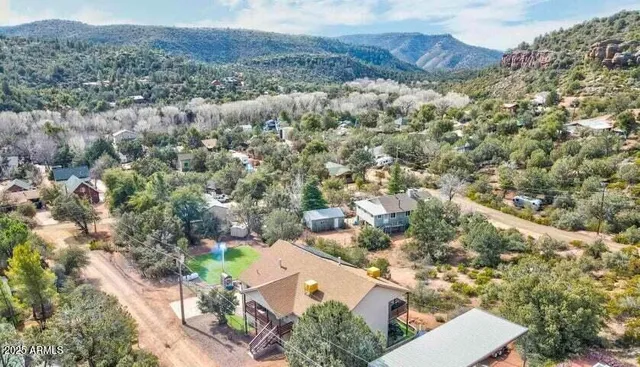 an aerial view of a house with a yard