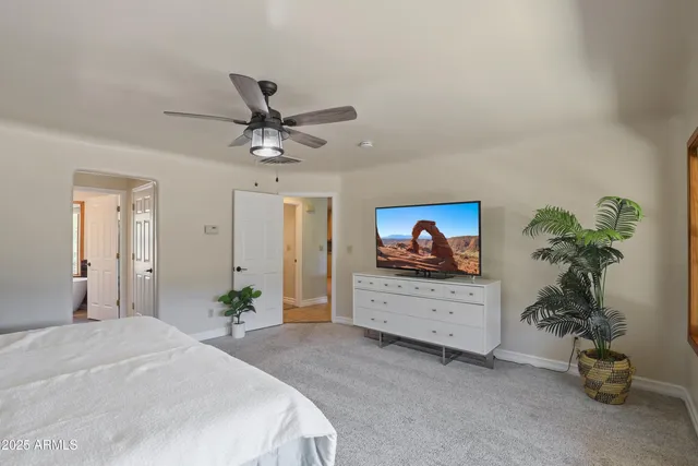 a bedroom with a bed and a potted plant
