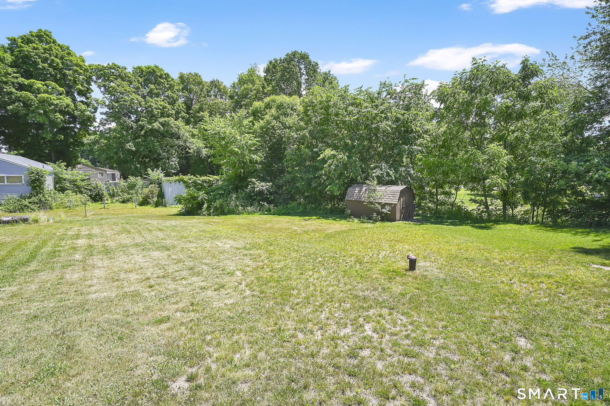 296 Phoenix Street Vernon, CT 06066 - Photo 25 of 34 a view of a green field with lots of bushes