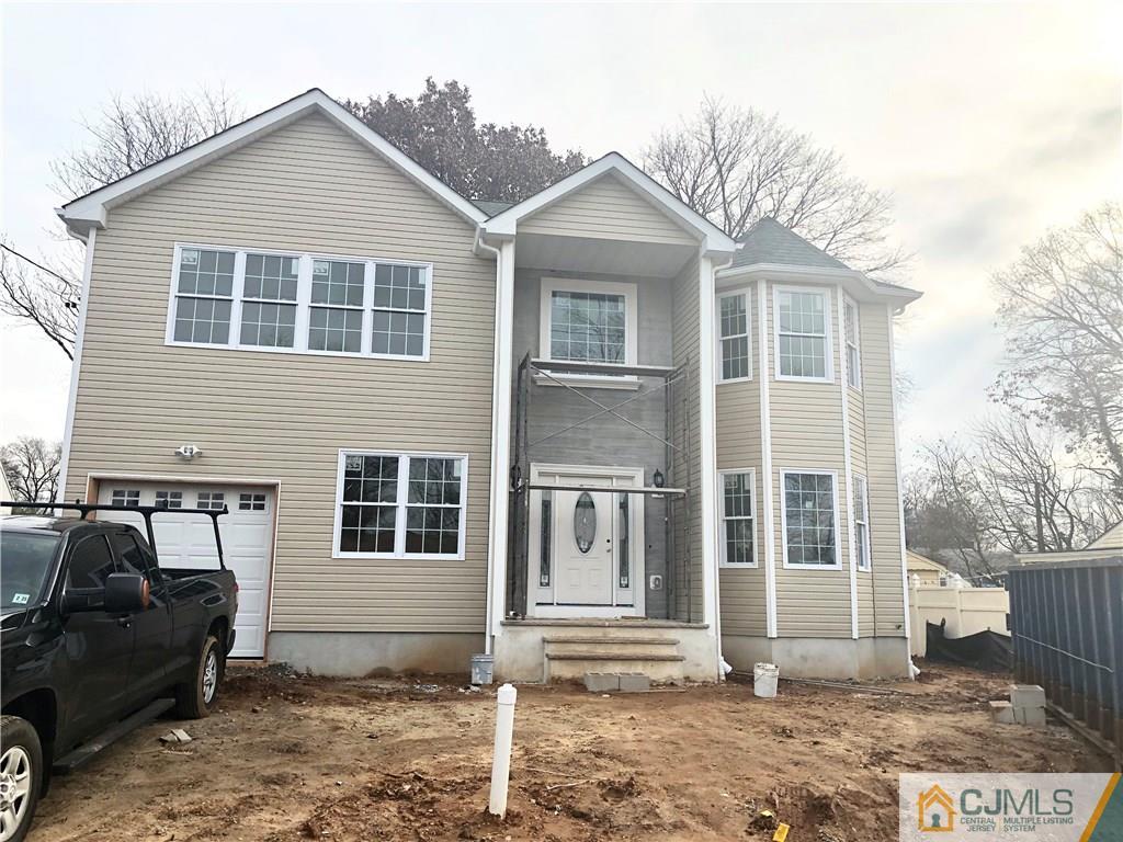 14 Comstock Road Edison, NJ 08817 - Photo 1 of 2 a front view of a house with a yard