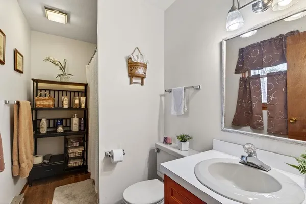 a bathroom with a sink toilet and a mirror