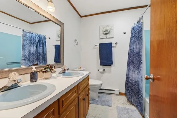 a bathroom with a double vanity sink mirror and shower