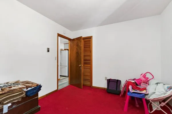 a bedroom with a bed and a desk