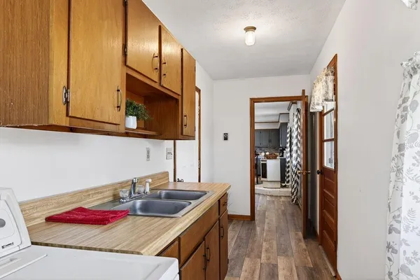 a en suite bathroom with a granite countertop sink and a mirror