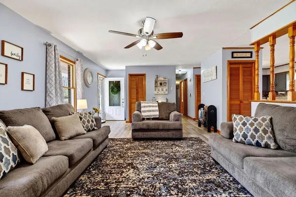 a living room with furniture ceiling fan and a rug