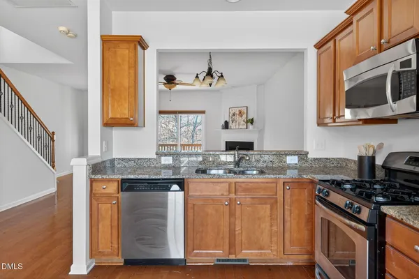 a kitchen with stainless steel appliances granite countertop a stove and a microwave