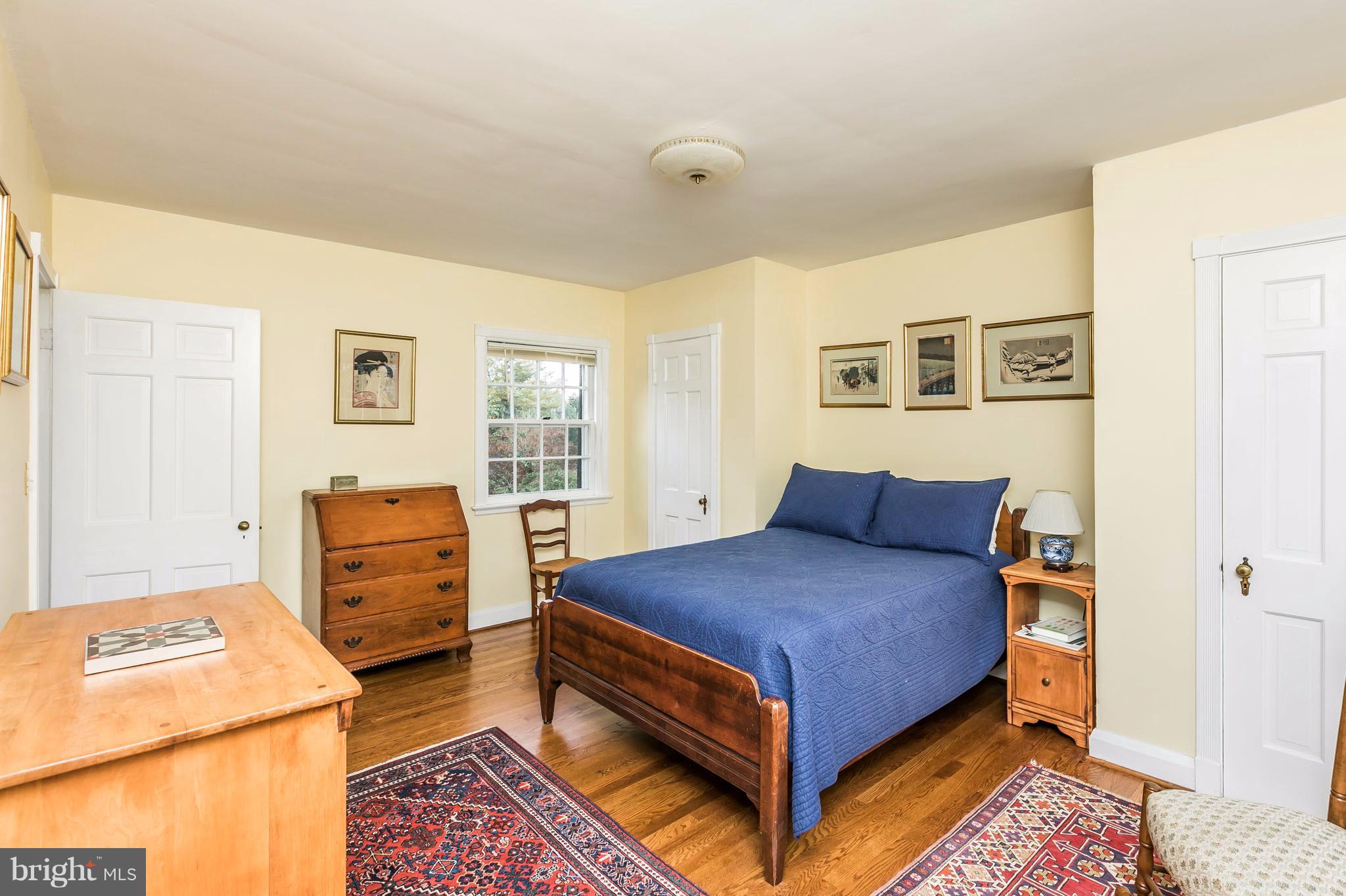 5701 Greenleaf Road Baltimore, MD 21210 - Photo 22 of 30 a bedroom with a bed and wooden floor