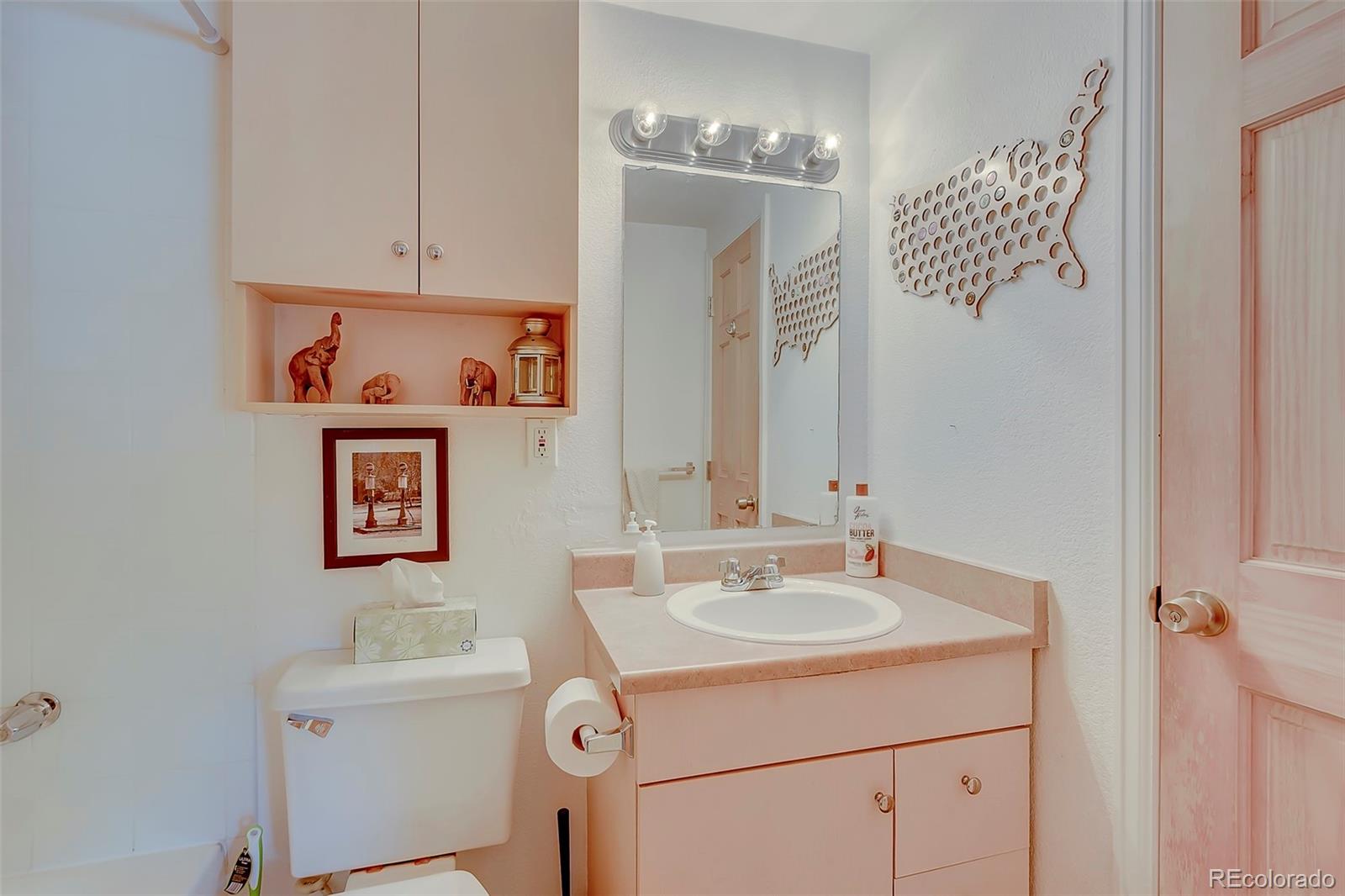 336 Grant Street, Unit 102 Denver, CO 80203 - Photo 11 of 22 a bathroom with a sink and a mirror