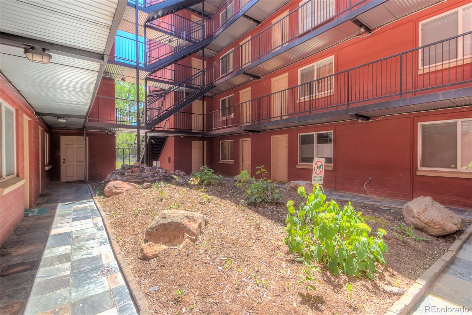 336 Grant Street, Unit 102 Denver, CO 80203 - Photo 19 of 22 a view of a building with a yard