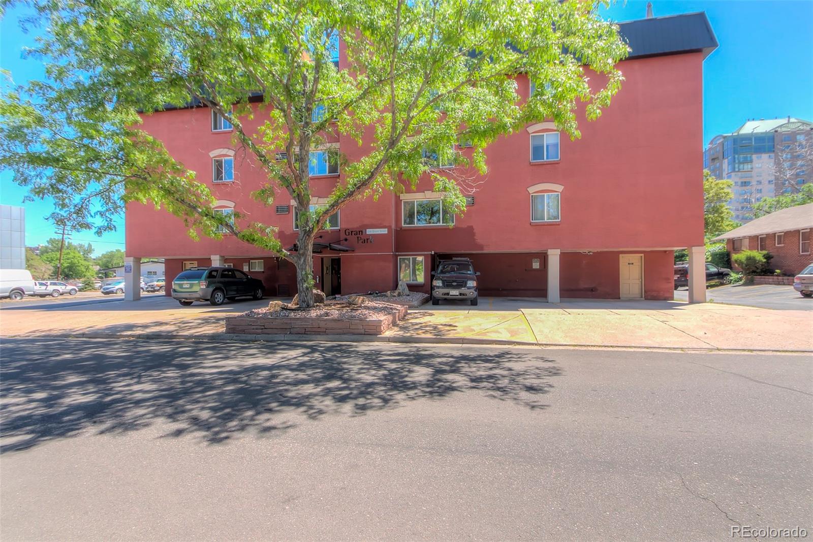336 Grant Street, Unit 102 Denver, CO 80203 - Photo 20 of 22 a view of a house with a yard and a large tree