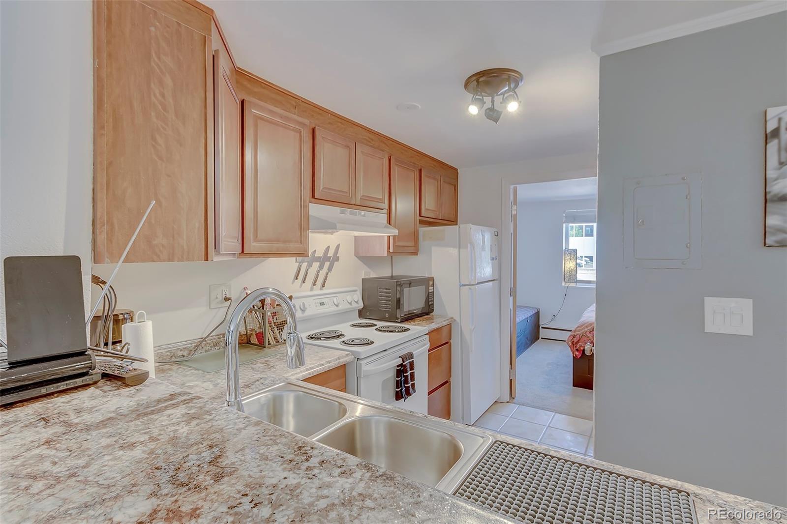336 Grant Street, Unit 102 Denver, CO 80203 - Photo 5 of 22 a kitchen that has a sink and a stove top oven