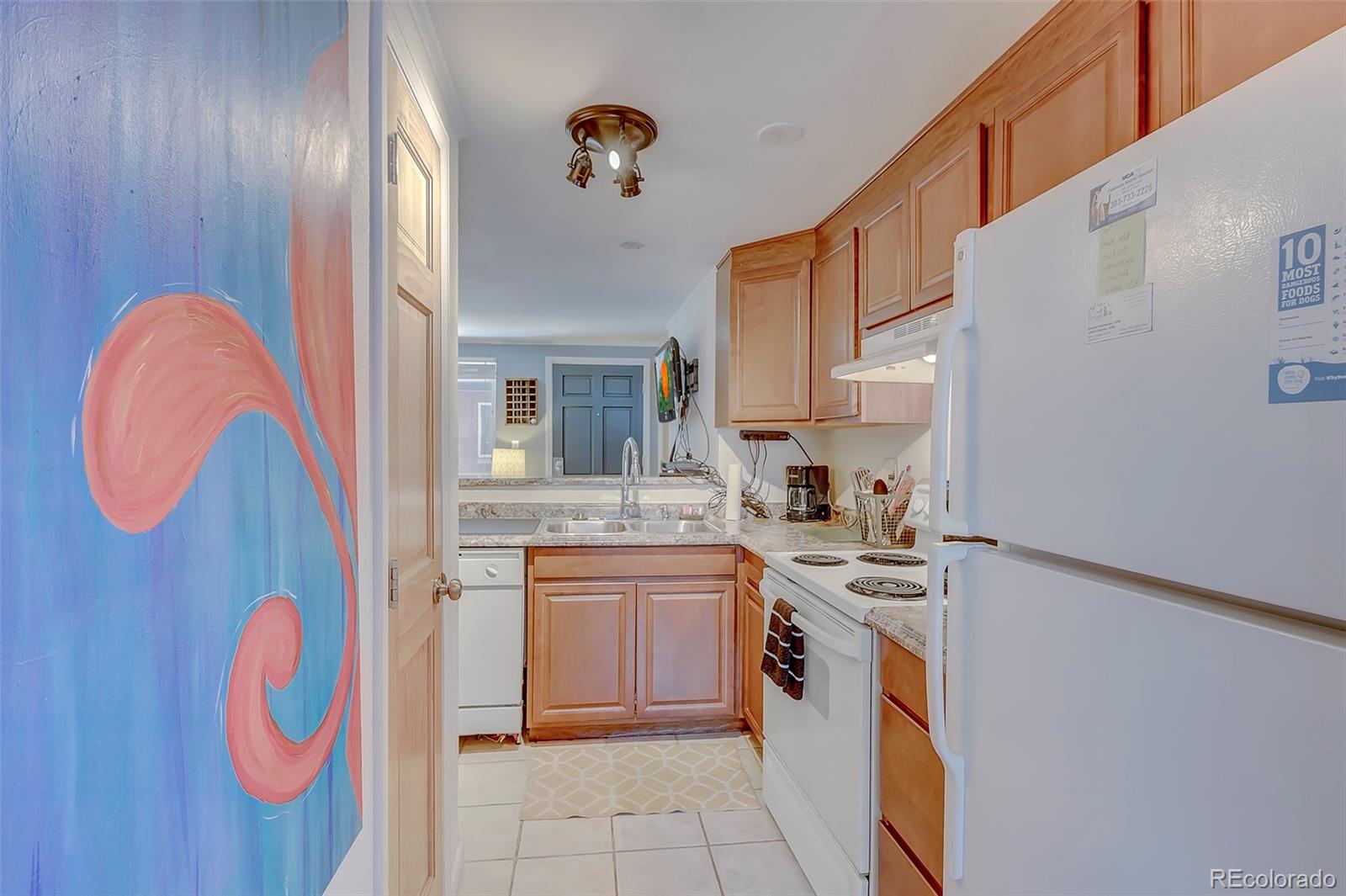336 Grant Street, Unit 102 Denver, CO 80203 - Photo 7 of 22 a kitchen with stainless steel appliances granite countertop a sink and cabinets