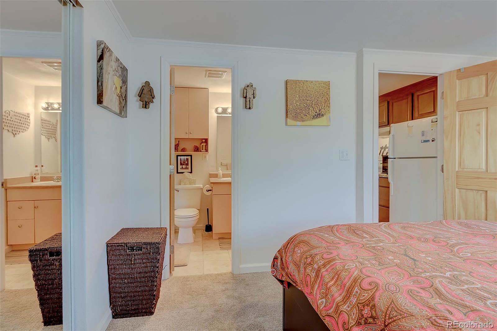 336 Grant Street, Unit 102 Denver, CO 80203 - Photo 10 of 22 a bedroom with a bed and a painting on the wall