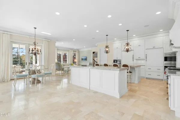 a kitchen with stainless steel appliances granite countertop a sink and a refrigerator