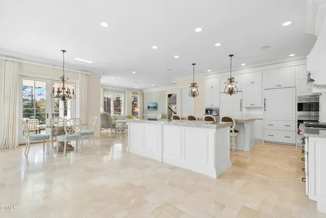 a kitchen with stainless steel appliances granite countertop a sink and a refrigerator