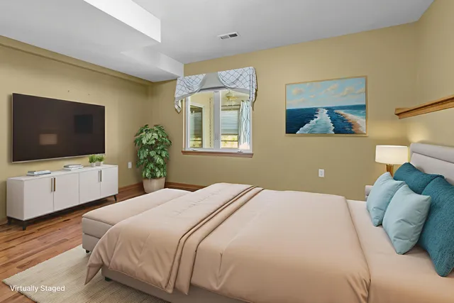 a bedroom with a bed and a flat screen tv
