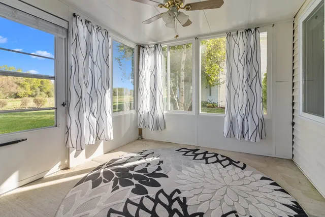 a view of a bedroom with a bed and a window