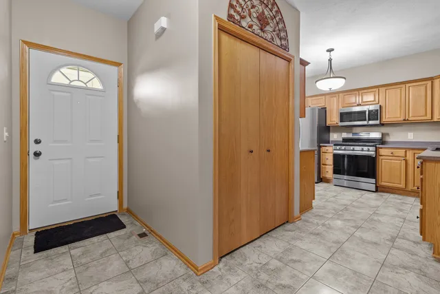 a kitchen with stainless steel appliances granite countertop a refrigerator and a sink