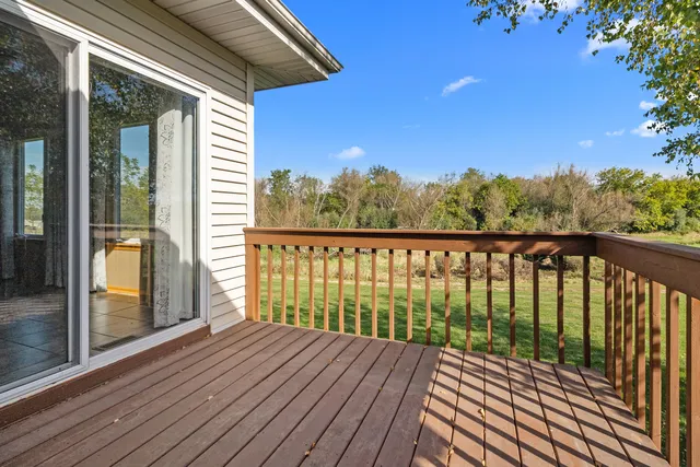 a view of a balcony with wooden floor and outdoor space