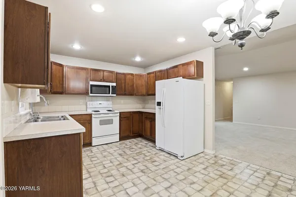 a kitchen with a refrigerator a sink and dishwasher
