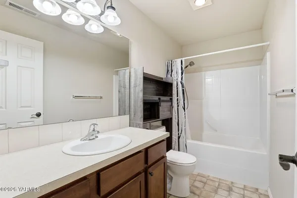 a bathroom with a sink toilet a mirror and shower