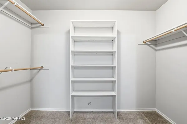 a view of walk in closet with empty racks