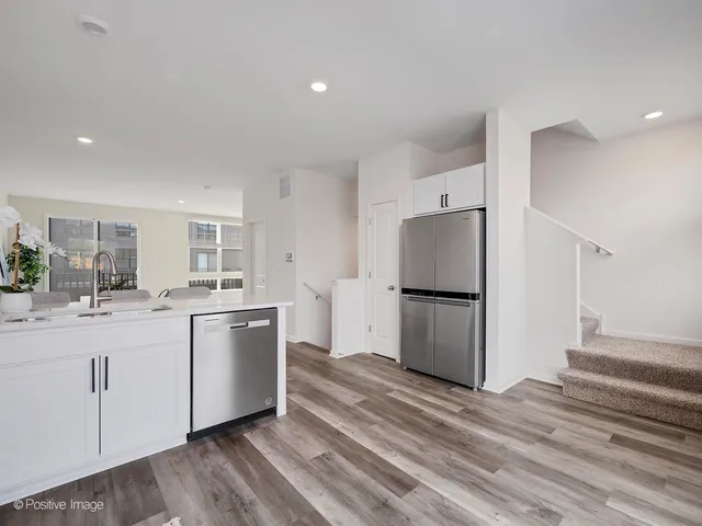 a kitchen with a refrigerator and a sink