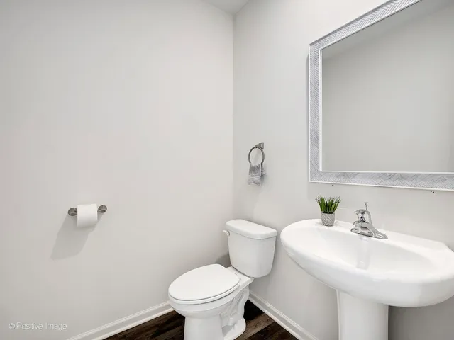 a bathroom with a sink toilet and a mirror