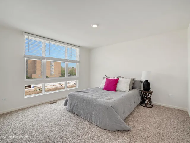 a bed room with a bed and a large window