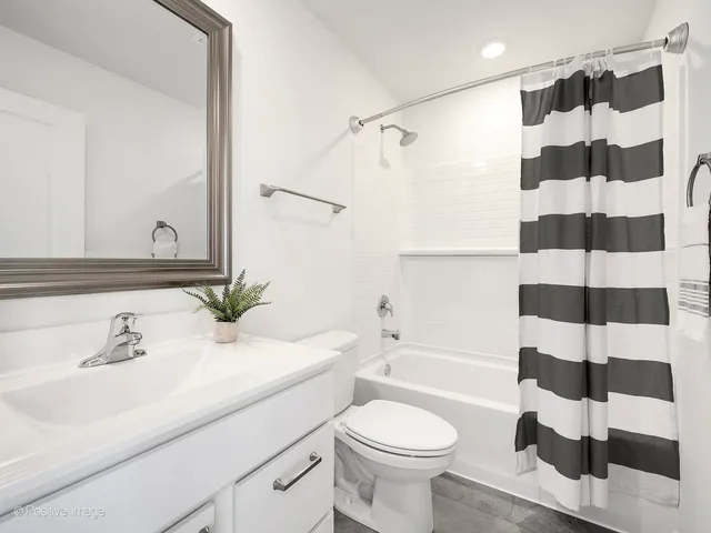 a bathroom with a sink a toilet a shower and a mirror