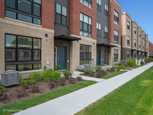 a view of a brick building next to a yard