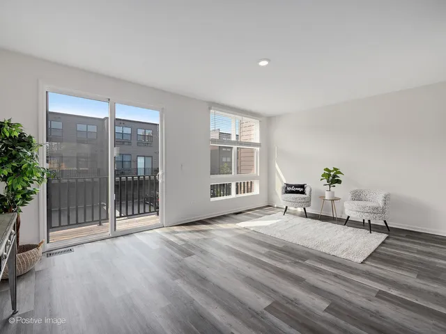 a view of a livingroom with furniture and windows