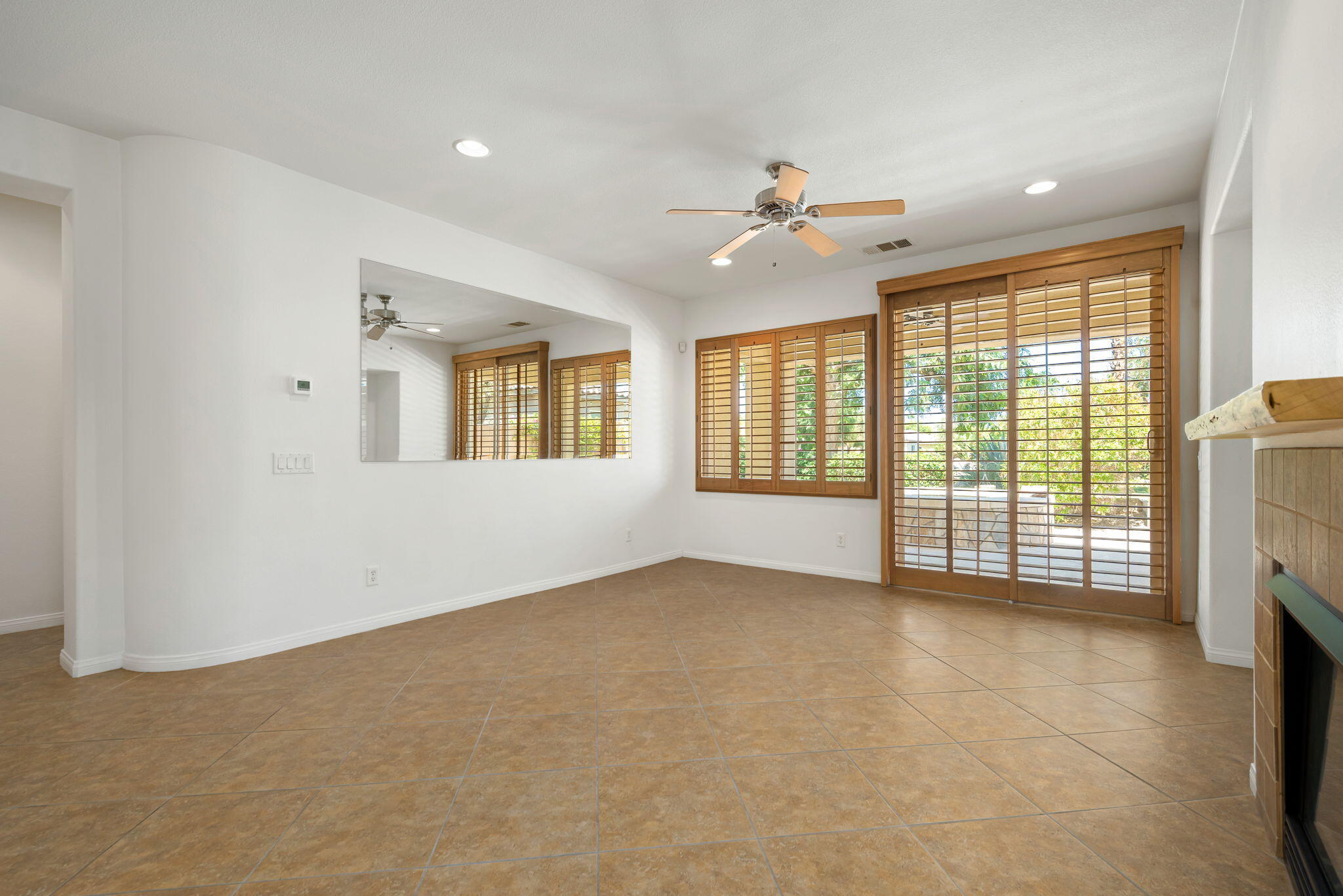 49728 Pacino Street Indio, CA 92201 - Photo 15 of 54 a view of an empty room with a fireplace and a window