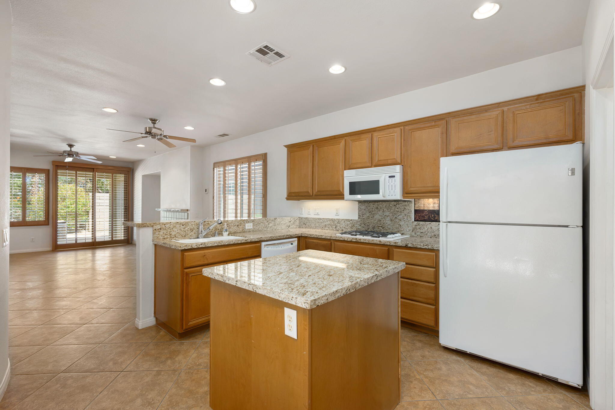 49728 Pacino Street Indio, CA 92201 - Photo 19 of 54 a kitchen with a refrigerator and a sink