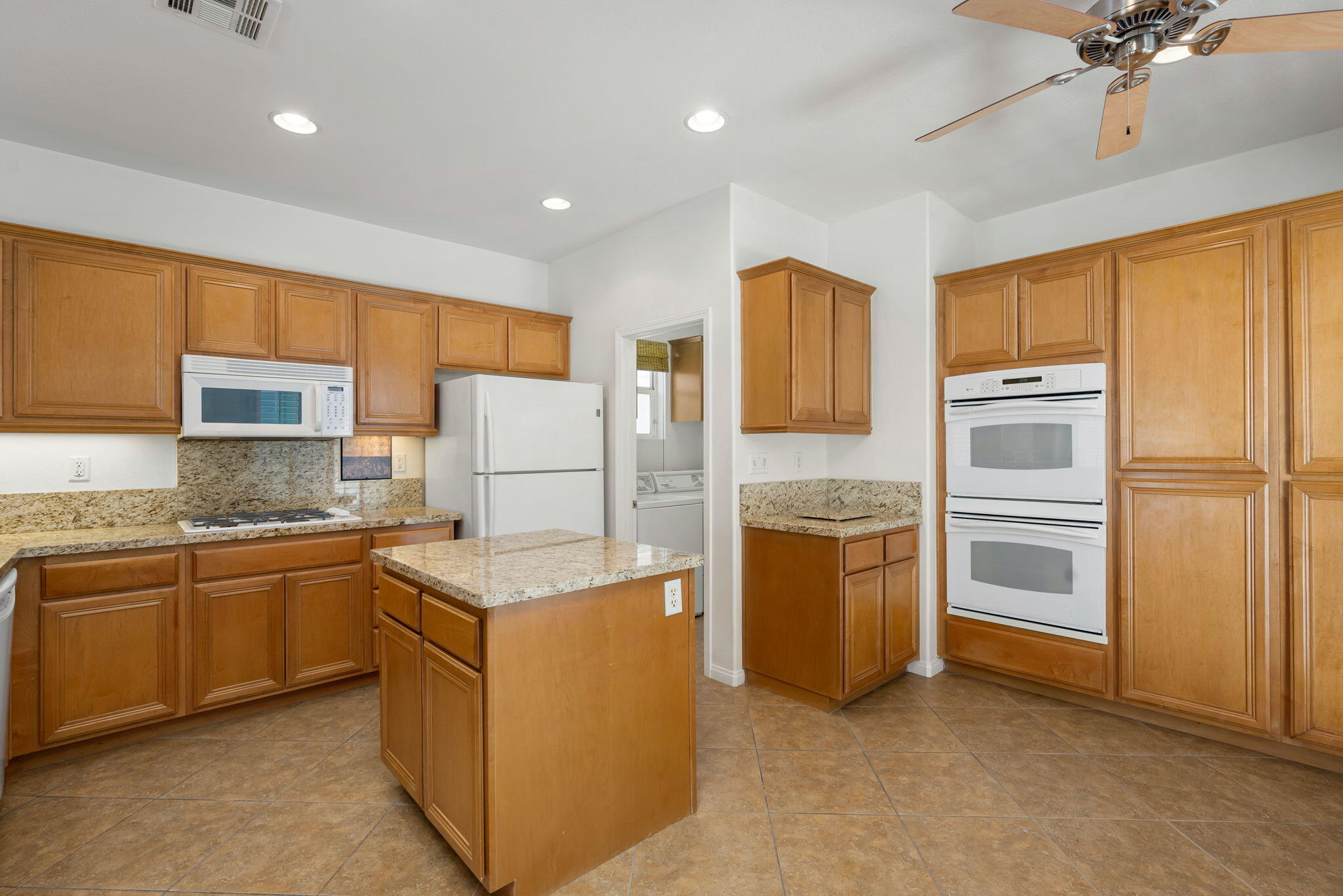 49728 Pacino Street Indio, CA 92201 - Photo 21 of 54 a kitchen with stainless steel appliances granite countertop a refrigerator a stove a sink and a refrigerator