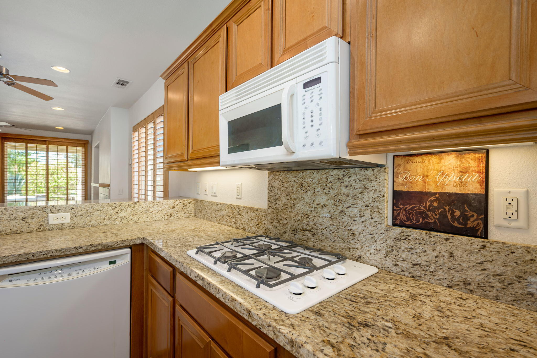 49728 Pacino Street Indio, CA 92201 - Photo 23 of 54 a kitchen with stainless steel appliances granite countertop a sink stove and cabinets