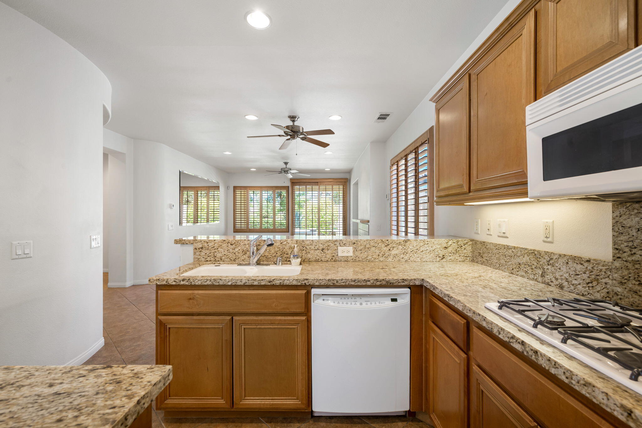 49728 Pacino Street Indio, CA 92201 - Photo 24 of 54 a kitchen with granite countertop a sink stainless steel appliances and cabinets