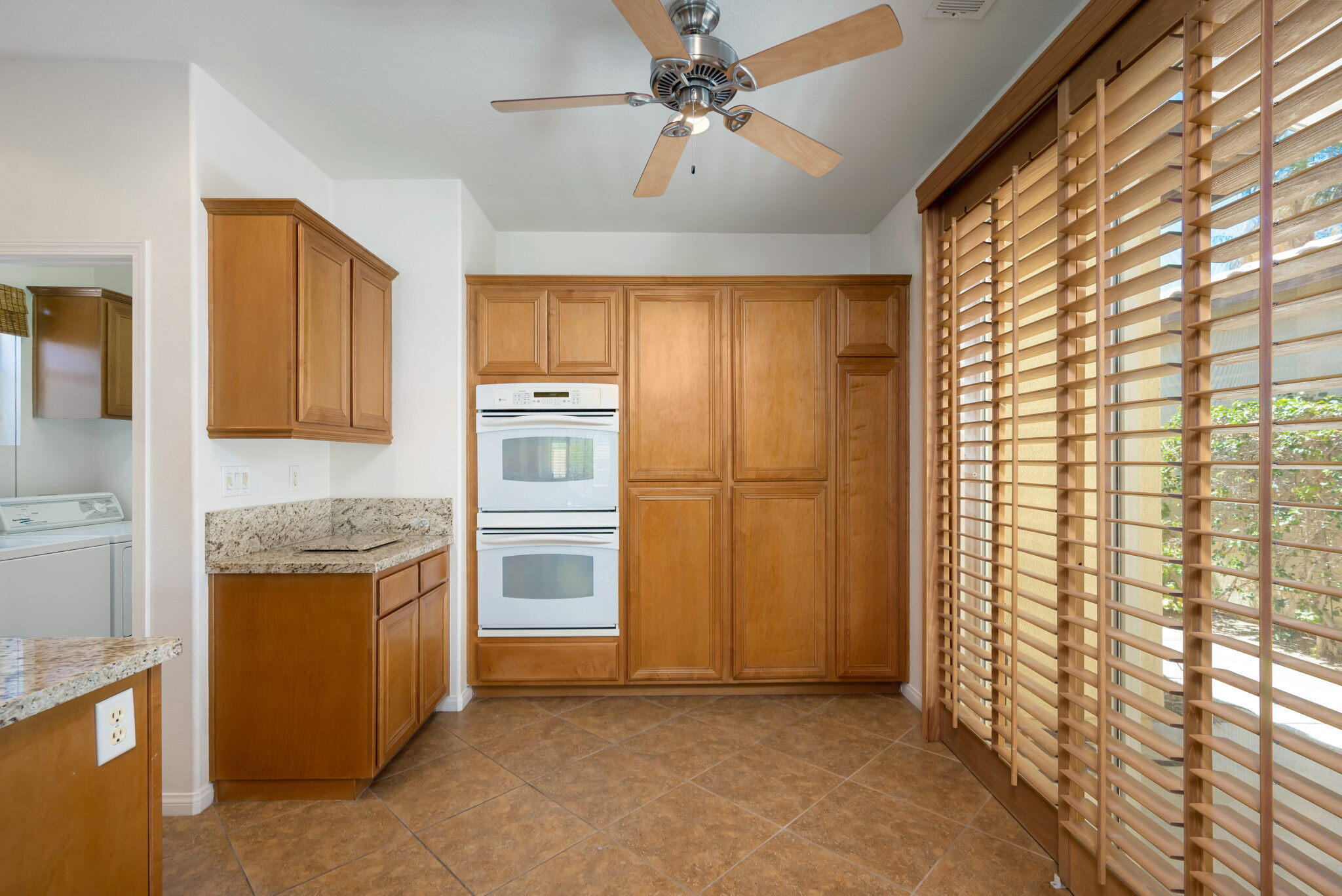 49728 Pacino Street Indio, CA 92201 - Photo 26 of 54 a kitchen with stainless steel appliances granite countertop a refrigerator and a stove