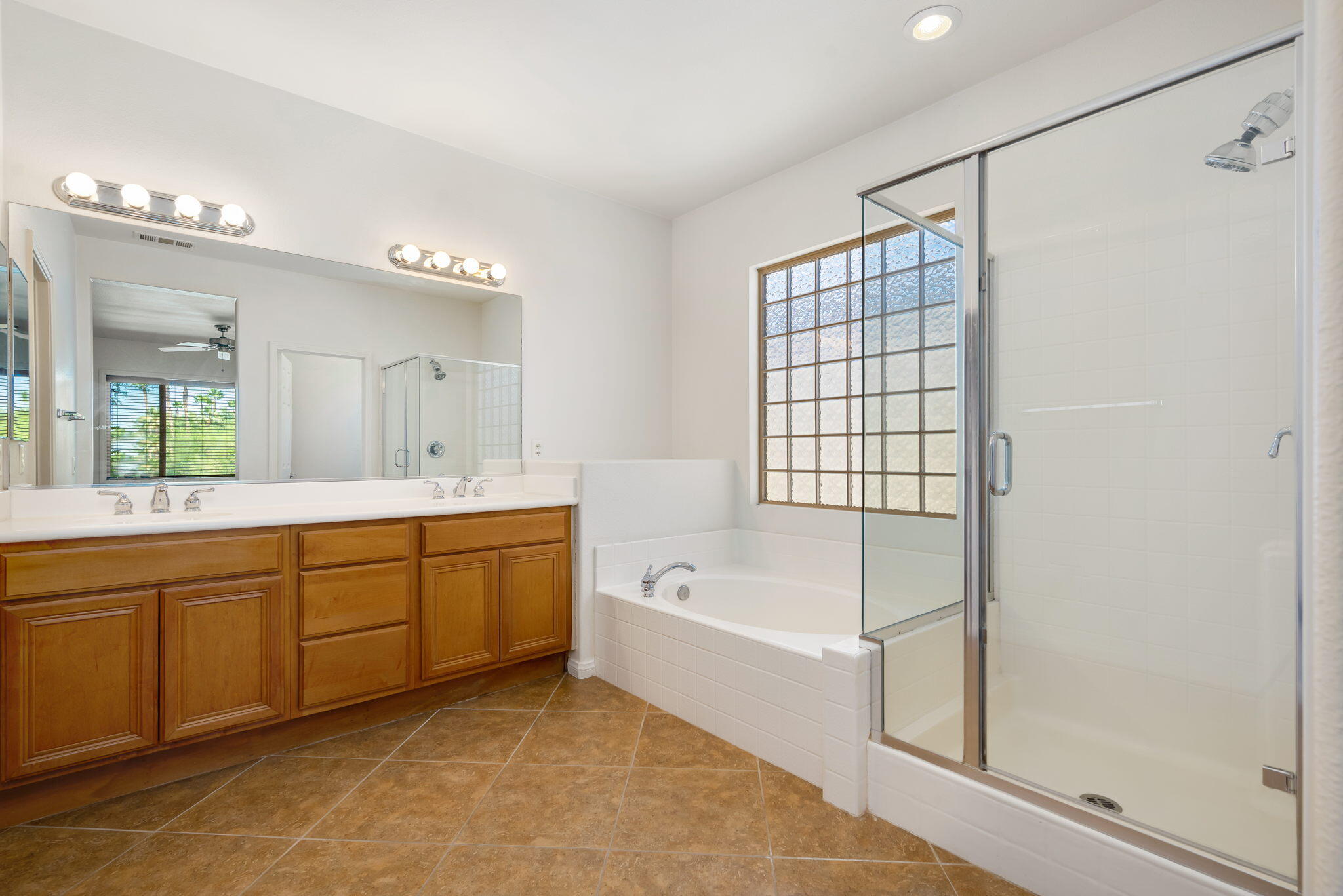 49728 Pacino Street Indio, CA 92201 - Photo 29 of 54 a spacious bathroom with a tub sink shower and mirror