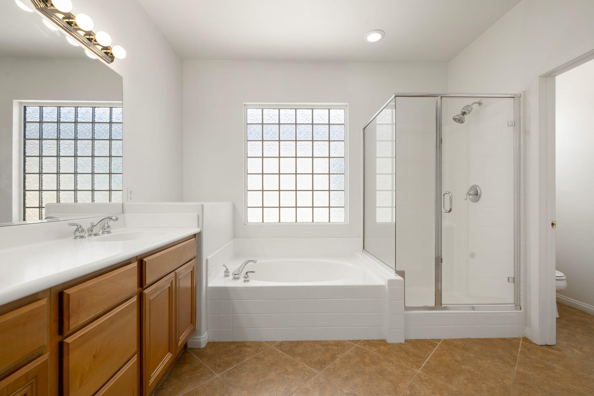 49728 Pacino Street Indio, CA 92201 - Photo 30 of 54 a bathroom with a tub sink and mirror