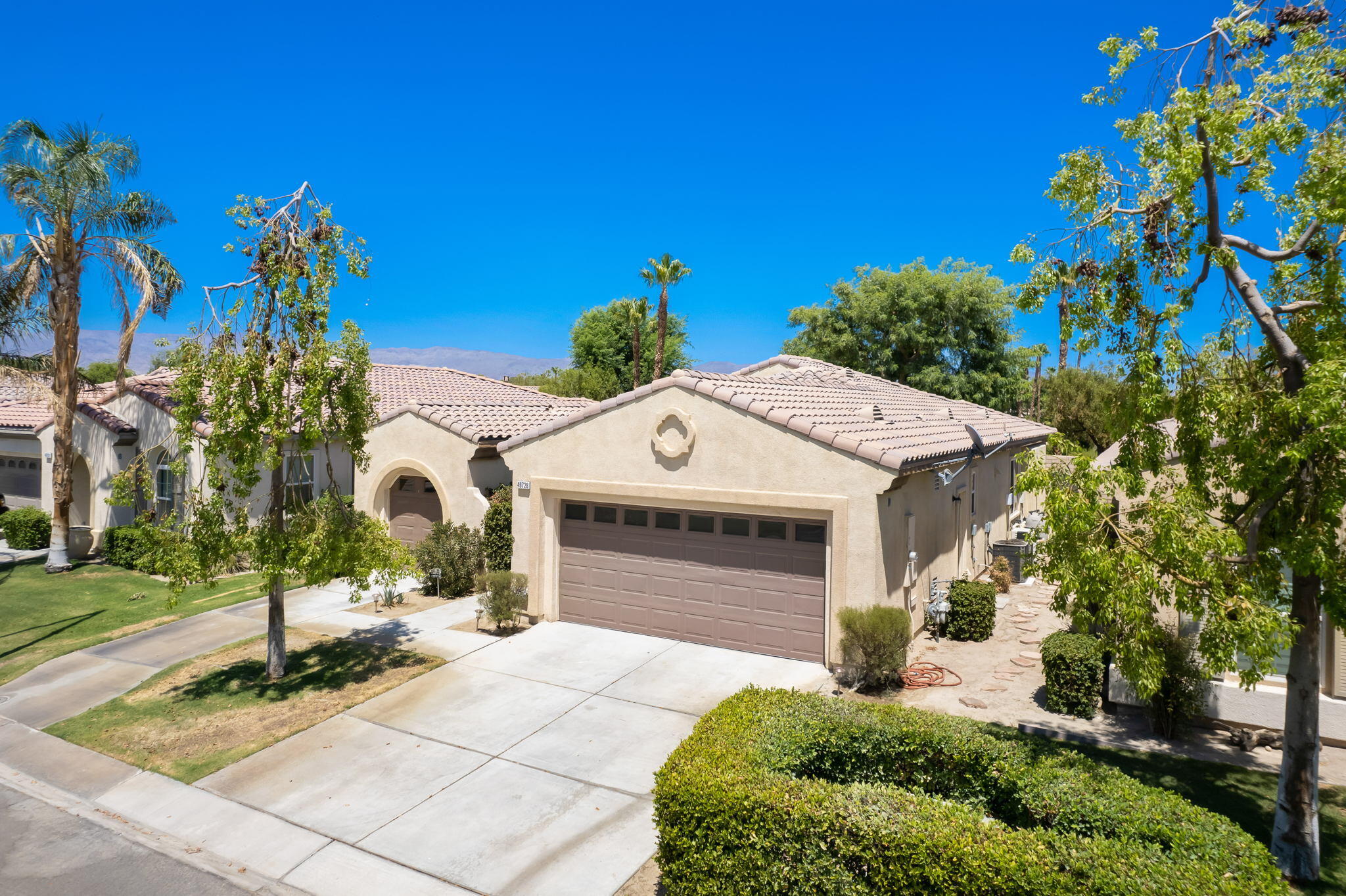 49728 Pacino Street Indio, CA 92201 - Photo 3 of 54 a front view of a house with a yard
