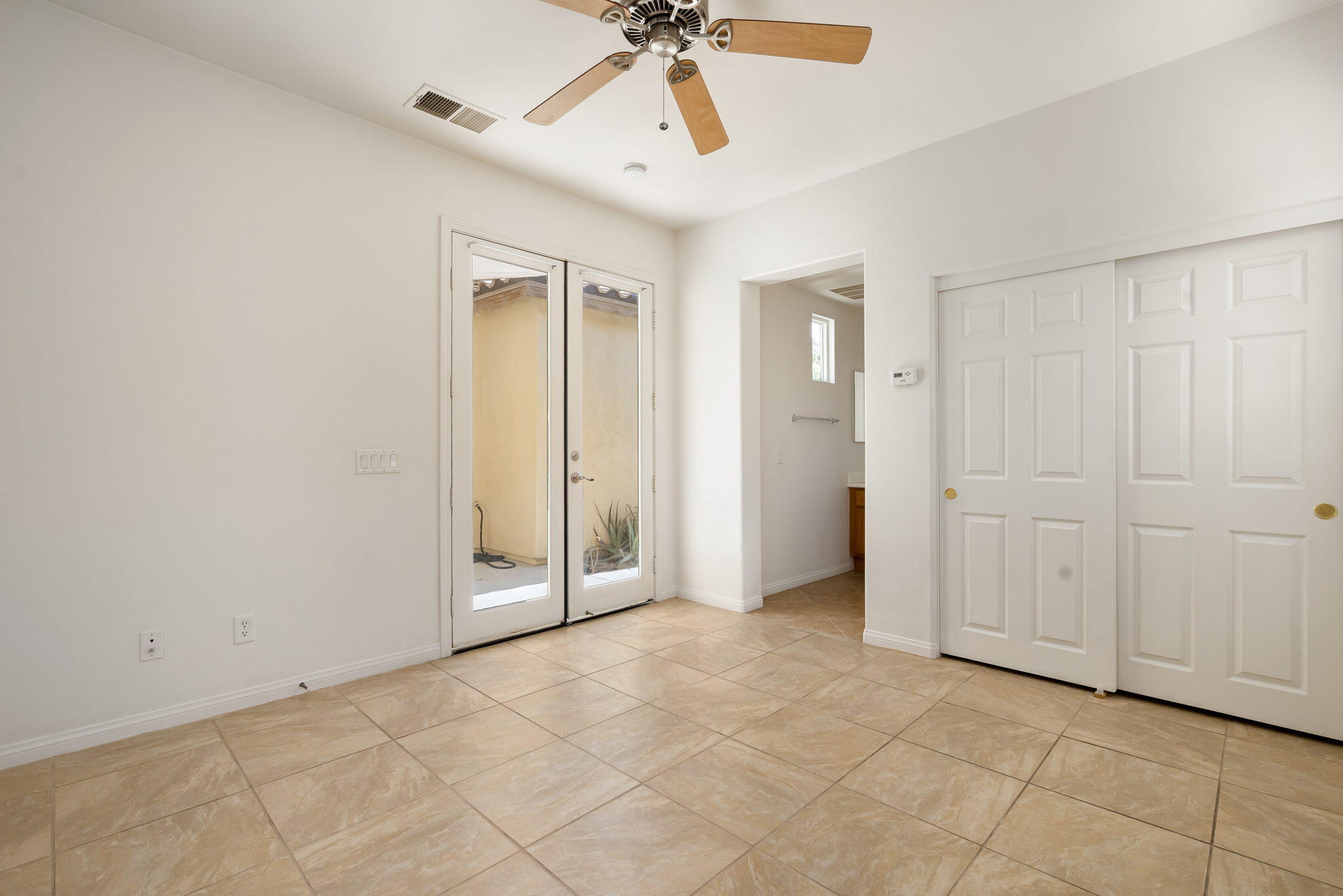 49728 Pacino Street Indio, CA 92201 - Photo 34 of 54 an empty room with fan and entrance